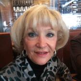 Here's a short alt tag for the image: Portrait of a smiling blonde woman.